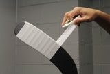 white hockey tape wrapping a black hockey stick